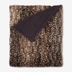 an animal print blanket folded on top of each other