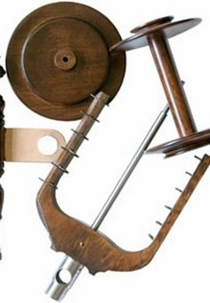 an old wooden spinning wheel and other woodworking tools on a white background with clippings