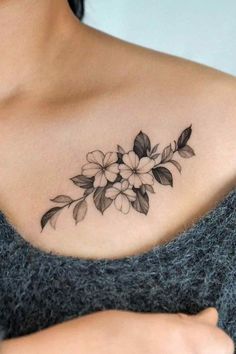 a woman with a flower tattoo on her chest