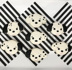 black and white cupcakes with dog faces on them are arranged in the shape of squares