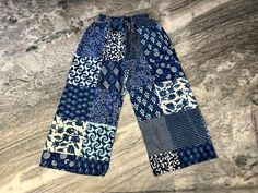 a pair of blue and white patterned pants sitting on top of a marble countertop