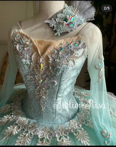 the back of a ball gown with beading and appliqued details on it