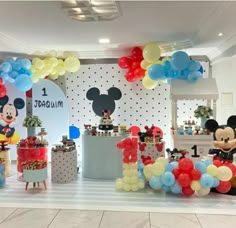 a mickey mouse themed birthday party with balloons