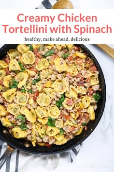 a skillet filled with tortelli shells and spinach on top of a white table