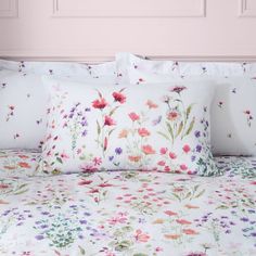 an image of a bed with flowers on it in the day light room or bedroom