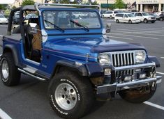 a blue jeep parked in a parking lot