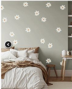 a bedroom with white and yellow flowers on the wall