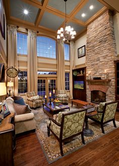 a living room filled with furniture and a fire place in the middle of a room