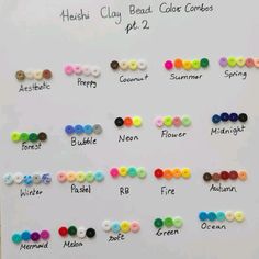 a white board with many different colored buttons on it's side and the words henshu clay bead color cards written below