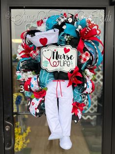 a wreath that says nurse life is hanging on the front door with red, white and blue decorations