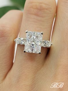 a woman's hand with a diamond ring on it