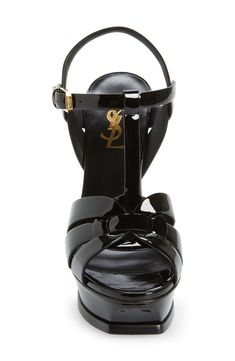 An icon since it first debuted on the runway, Saint Laurent's stylishly strappy Tribute sandal is lifted by a soaring tapered heel and beveled platform sole. 5" (127mm) heel; 1 1/4" platform (size 38.5) Adjustable ankle strap with buckle closure Leather upper, lining and sole Made in Italy Women's Designer Shoes Footwear Design Women, Sandal Women, T Strap, Platform Sandals, Designer Shoes, Designing Women, Ankle Strap, Womens Sandals, Saint Laurent