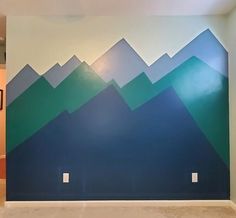 an empty room with mountains painted on the wall