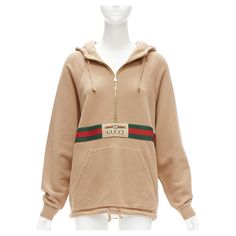 GUCCI Alessandro Michele beige cotton half zip vintage logo pullover XS Reference: LNKO/A02246 Brand: Gucci Designer: Alessandro Michele Model: 644656 XJC3W 2603 Material: Cotton Color: Beige, Multicolour Pattern: Striped Closure: Half Zip Lining: Beige Fabric Extra Details: Reminiscent of a vintage tracksuit, this hooded sweatshirt features a front zip detail and contrast red piping. Emblematic House codes, like the green and red Web stripe and the Gucci jacquard label, enrich the design. Made Gucci Alessandro Michele, Vintage Tracksuit, Zip Lining, Red Web, Gucci Brand, Gucci Outfits, Gucci Designer, Women Overcoat, Logo Vintage