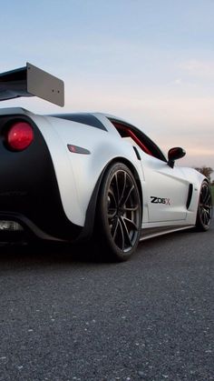 a white and black sports car parked on the street