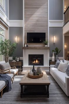 a living room filled with furniture and a flat screen tv mounted on the wall above a fire place