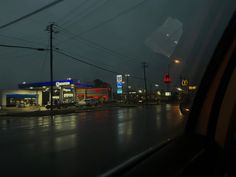 a gas station at night in the rain