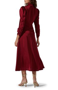 Voluminous ties twist and knot at the mock neck of this A-line dress finished with lightly puffed shoulders and ruched sleeves. Mock neck with ties Long sleeves Lined 100% polyester Dry clean Imported Fall A-line Midi Dress With Pleated Sleeves, Fitted Long Sleeve Puff Sleeve Dress In Solid Color, Elegant Fall Puff Sleeve Dress With Pleated Sleeves, Fall Solid Color Puff Sleeve Dress, Fall Pleated Solid Midi Dress, Pleated Midi Dress For Fall, Fall Midi Dress With Puff Sleeves In Solid Color, Fall Party Midi Dress With Elastic Sleeves, Fall Puff Sleeve Dress In Solid Color