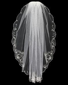 the back of a wedding veil with lace trims and beaded edges on a black background