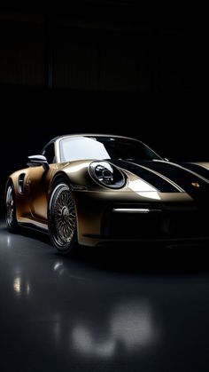 a gold colored sports car in a dark room