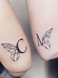 two small tattoos on the legs of people with letters and butterflies in them, one is letter c