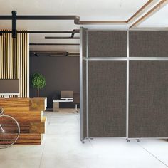 a room divider in the middle of an office with a bike parked next to it