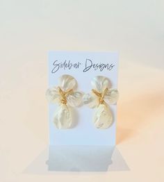 These mother of pearl earrings are handmade. Very elegant while making such a statement. They are great for every day wear, bridal earrings, bridesmaid earrings, and more.  Dimensions: approx. 2" Hypoallergenic gold plated & light weight If you purchase 6 or more, use discount code Bridesmaids15 for 15% off! Handmade White Mother Of Pearl Earrings, Handmade White Earrings In Mother Of Pearl, Pearl White Drop Clip-on Earrings For Gift, Pearl White Drop Clip-on Earrings As Gift, Unique White Pearl Earrings For Pierced Ears, Unique Mother Of Pearl Drop Earrings, Unique White Pearl Earrings, Pearl White Clip-on Earrings With Pearl Drop For Gift, Unique White Dangle Pearl Earrings