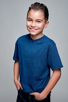 a young boy is smiling and posing for the camera