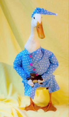 a stuffed duck dressed in blue and white