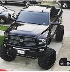 a large black truck parked on the side of a road next to a parking meter