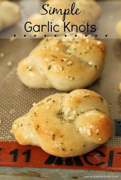 garlic knots on a baking sheet with text overlay that reads simple garlic knot recipe