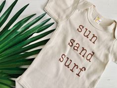 Go for a dip with our Sun Sand Surf Baby Bodysuit. This gender neutral, short sleeve onesie is perfect for any beach-loving babe. With a playful vibe and cool design, your little one will be ready to catch some waves (or just some z's). Time to soak up some fun in the sun! Onesie Ideas, Surf Baby, Pray For Surf, Sand Surfing, Baby G, Fun In The Sun, Cool Design, Beach Themes, Baby Bodysuit