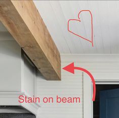 an open door with the word stain on beam above it and red arrow pointing up