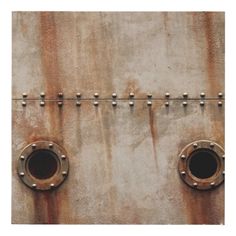 an old rusted metal surface with rivets and round holes