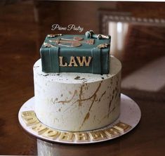 a cake that is sitting on top of a table with the words law written on it