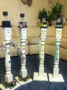 three snowmen are standing on top of each other in the middle of a living room