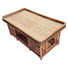 a wicker coffee table with two shelves on each side