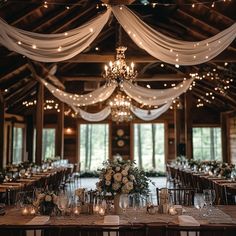 the tables are set with candles, flowers and greenery for an elegant wedding reception