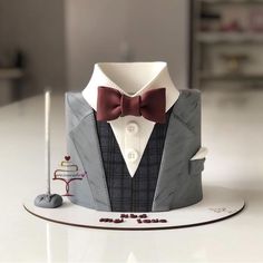 a cake that is shaped like a tuxedo with a bow tie on it