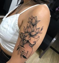 a woman's arm with a flower tattoo on the left side of her body