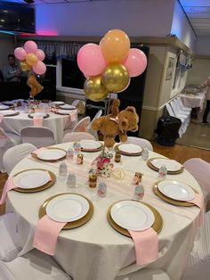 a teddy bear sitting on top of a table surrounded by plates and silver wares