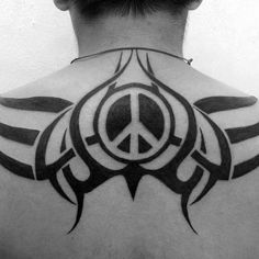 the back of a man's neck with a peace sign tattoo on his chest