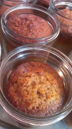 there are many desserts in glass bowls on the table