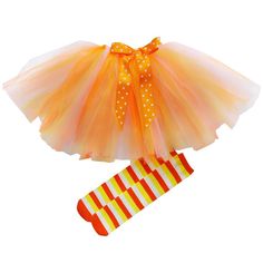 an orange and yellow tutu skirt with polka dots on it, next to a pair of socks