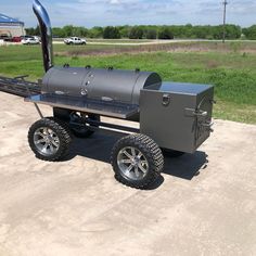 an outdoor bbq grill on wheels with the door open to show it's side