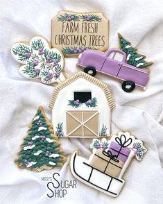 decorated sugar cookies with farm fresh christmas trees on them and a pink truck in the background