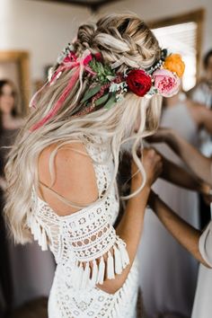 a woman with flowers in her hair is getting ready to go on the dance floor