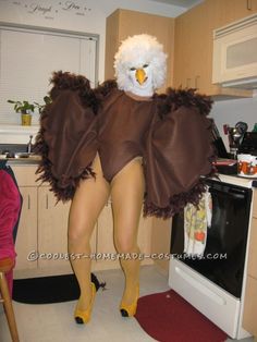 an eagle costume is standing in the kitchen