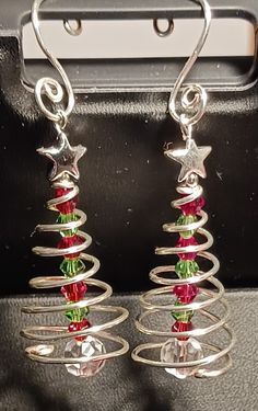 silver christmas tree earrings with red, green and clear crystal beads on wire wrapped around them