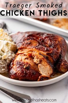 a white plate topped with chicken thighs and mashed potatoes